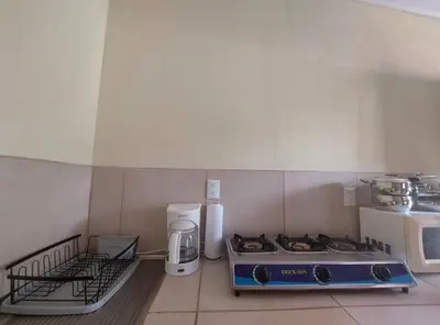 a kitchen with a stove and a microwave at La Paz in Bahia