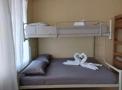 two white swans sitting on a bunk bed at La Paz in Bahia