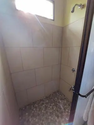 a bathroom with a shower with a glass door at La Paz in Bahia