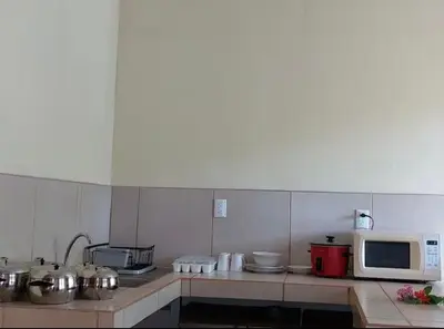 a kitchen with a microwave and some pots and pans at La Paz in Bahia