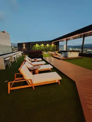 a row of lounge chairs on the roof of a building at Alma Verde Escalante 605 in San José