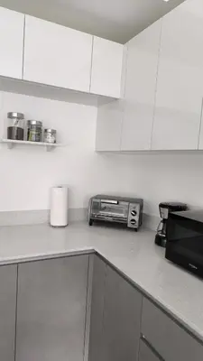 a kitchen with white cabinets and a toaster oven at Alma Verde Escalante 605 in San José