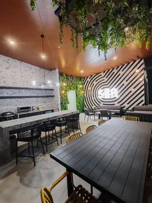 a restaurant with a large wooden table and chairs at Alma Verde Escalante 605 in San José