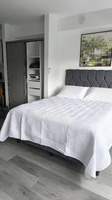 a bedroom with a large bed with a white comforter at Alma Verde Escalante 605 in San José