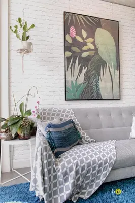 a couch in a living room with a picture on the wall at ART AND STYLE Wonderful space for a couple in San José