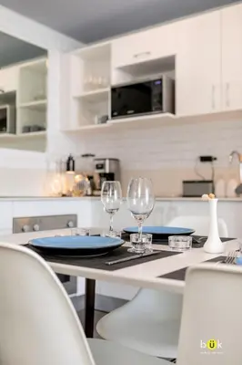 a kitchen with a table with two wine glasses at ART AND STYLE Wonderful space for a couple in San José