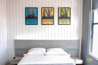 a bedroom with four pictures on the wall above a bed at ART AND STYLE Wonderful space for a couple in San José