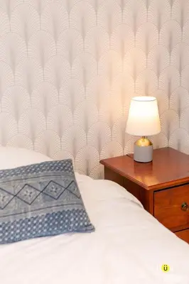 a bedroom with a bed and a table with a lamp at Charming 3BR in Trendy Neighborhood in San José