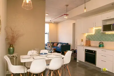 a kitchen and living room with a table and chairs at Charming 3BR in Trendy Neighborhood in San José