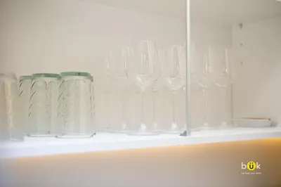 a row of wine glasses sitting on a shelf at Charming 3BR in Trendy Neighborhood in San José