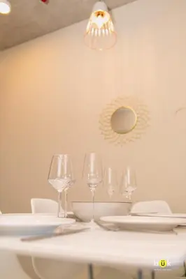 a white table with wine glasses and a light fixture at Charming 3BR in Trendy Neighborhood in San José