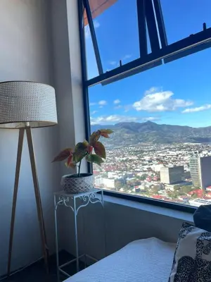 a bedroom with a window with a view of a city at Charming 3BR in Trendy Neighborhood in San José