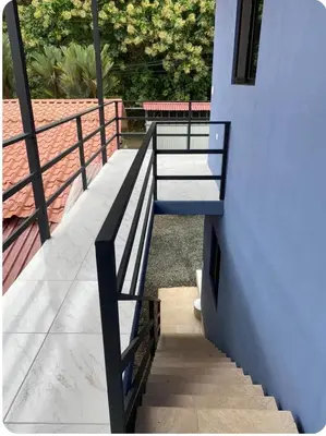 a railing on the side of a house with stairs at Apartamentos zafiro in Bahia