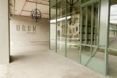 a row of glass doors in a building with the words urban signature at Cozy New Studio Excellent Location in San José