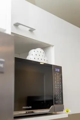 a microwave oven with two dishes on top of it at Cozy New Studio Excellent Location in San José