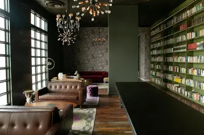 a library with leather couches and bookshelves at Cozy New Studio Excellent Location in San José