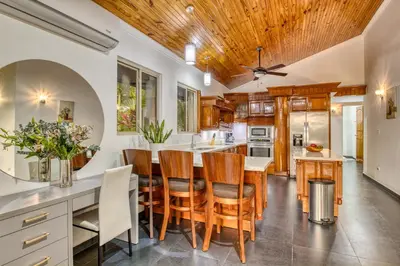 a kitchen with a table and chairs and a ceiling at Castillo Colonial Nosara - by Pura Villas in Nosara