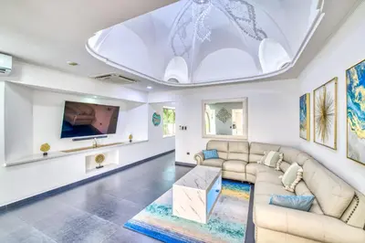 a living room with a couch and a tv at Castillo Colonial Nosara - by Pura Villas in Nosara