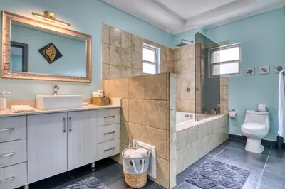 a bathroom with a tub and a toilet and a sink at Castillo Colonial Nosara - by Pura Villas in Nosara
