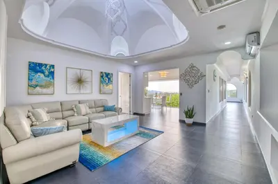 a living room with a couch and a table at Castillo Colonial Nosara - by Pura Villas in Nosara