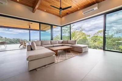 a living room with a couch and a table at Casa Vivo in Nosara