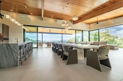 a dining room with a large table and chairs at Casa Vivo in Nosara