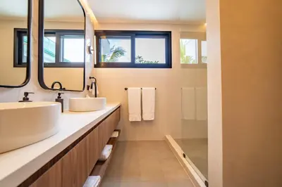 a bathroom with two sinks and a mirror at Casa Vivo in Nosara