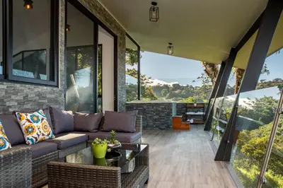 a living room with a couch and large windows at CasaYvyra 'i in Sierra