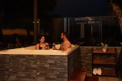 a man and woman in a bath tub at night at CasaYvyra 'i in Sierra