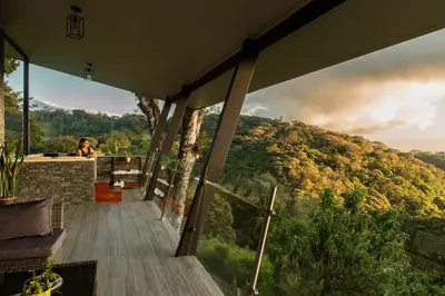 a woman standing in a room with a view of a mountain at CasaYvyra 'i in Sierra