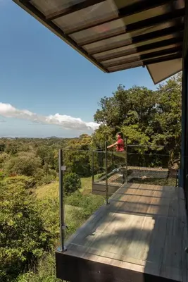 a person is standing on a balcony of a house at CasaYvyra 'i in Sierra