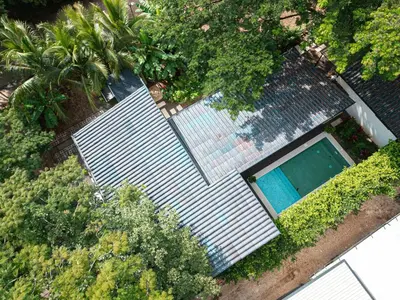 an overhead view of a swimming pool with trees and bushes at Tropical 4BR Retreat with Private Pool Guest House in Tamarindo