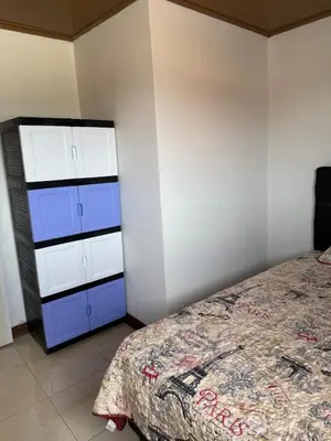 a bedroom with a bed and a dresser at Casa Tucán Turrialba in Turrialba