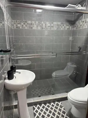 a bathroom with a shower and a sink and a toilet at Casa Tucán Turrialba in Turrialba