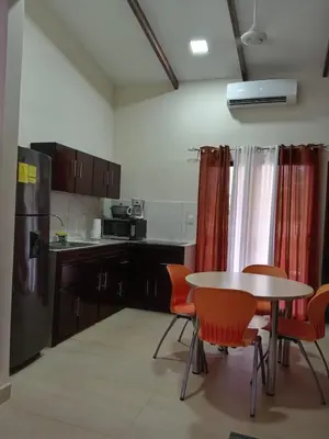 a kitchen with a table and some chairs and a table and a kitchen at Hacienda Paraíso Rio Celeste 1 in Rio Celeste