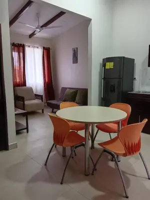 a living room with a table and chairs and a couch at Hacienda Paraíso Rio Celeste 1 in Rio Celeste