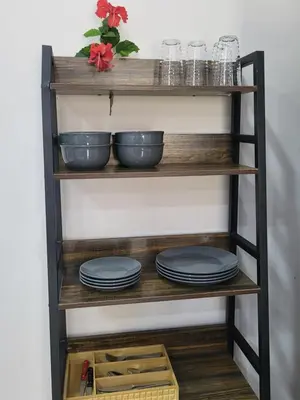 a shelf with plates and bowls on it at Villa Milagro in Parrita