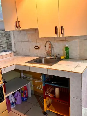 a kitchen with a sink and a counter top at Sol y Mar Condominio don Roberto in Jacó