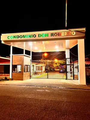 a gas station with a sign that reads condomino do ren fiction at Sol y Mar Condominio don Roberto in Jacó