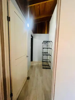 a hallway with a door and a ladder in a room at Apartamento con jardín privado in Coco