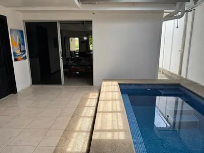 a swimming pool in the middle of a house at Casa Bela in Parrita