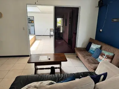 a living room with a couch and a table at Casa Bela in Parrita