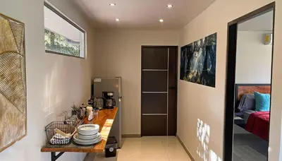 a kitchen with a table with plates on it at Mei Tai Cacao Lodge in Bijagua