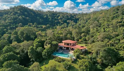 an aerial view of a house in the middle of a forest at Mei Tai Cacao Lodge in Bijagua