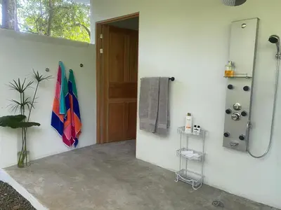 a bathroom with a shower and a towel hanging on the wall at Private Cabina at Yoga Center in Ojochal