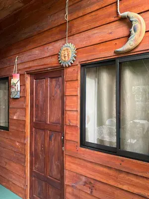 a wooden house with a door and a window at Cabin in Orosi in Orosí