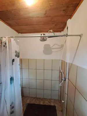 a bathroom with a shower with a shower curtain at Cabin in Orosi in Orosí