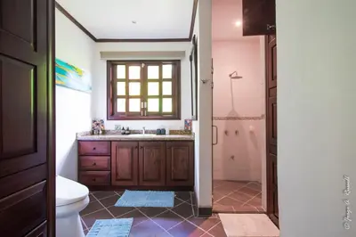 a bathroom with a toilet and a sink and a shower at Villa Azulita in Tarcoles