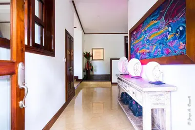 a hallway with a painting on the wall at Villa Azulita in Tarcoles