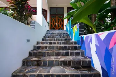 a staircase leading up to a house with a door at Villa Azulita in Tarcoles